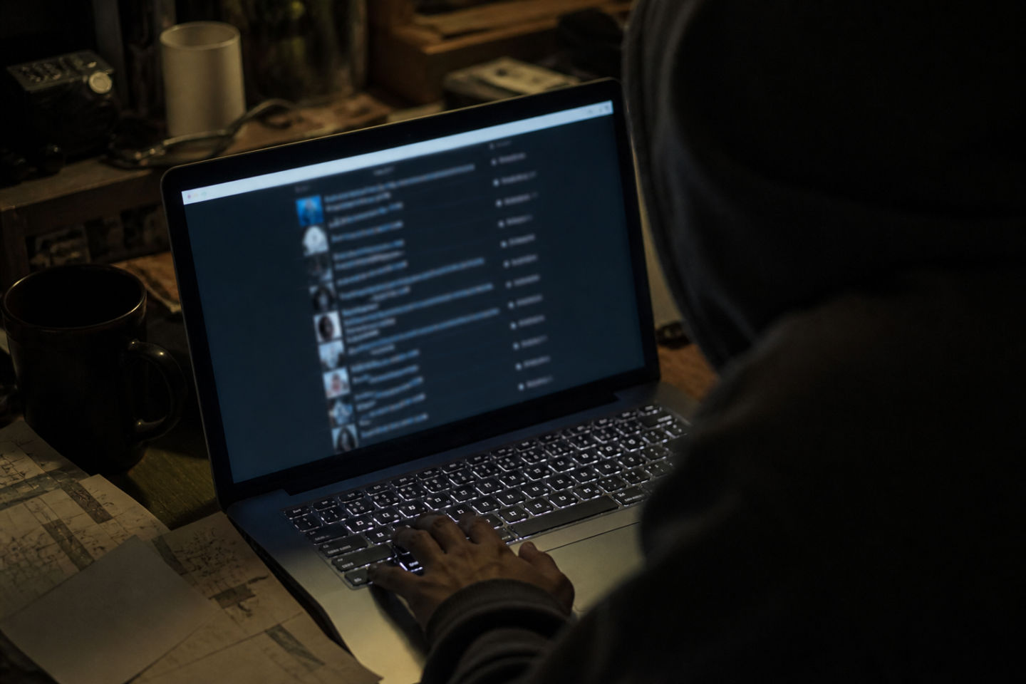 individual reviewing dark web number lists